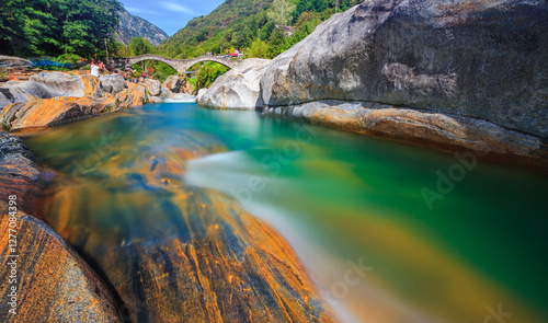 lake in the Valle Verzasca with blue turquoise water with long exposure frozen photo