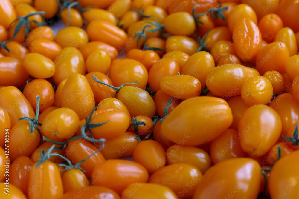 Small yellow or orange tomatoes. Close up. Small yellow or orange tomatoes. Close up.