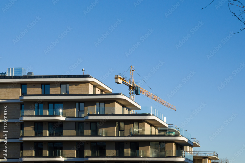 Modern Apartment Building with Construction Crane