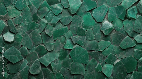 Emerald green crushed stone wall texture with rough irregular surfaces