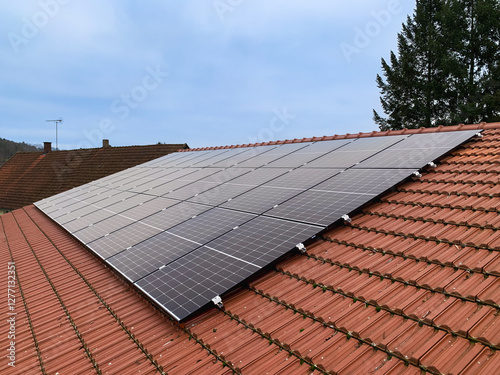 Red Tiled Roof of a Residential House with Installed Solar Panels