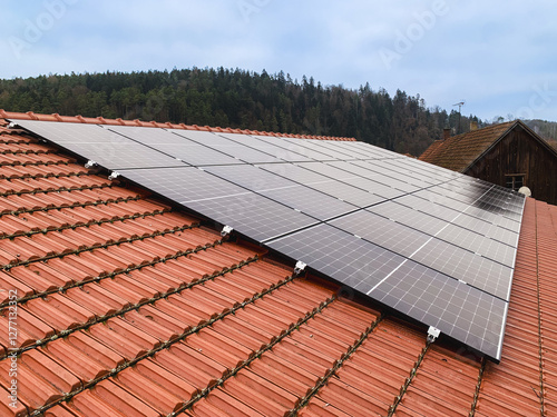 Red Tiled Roof of a Residential House with Installed Solar Panels