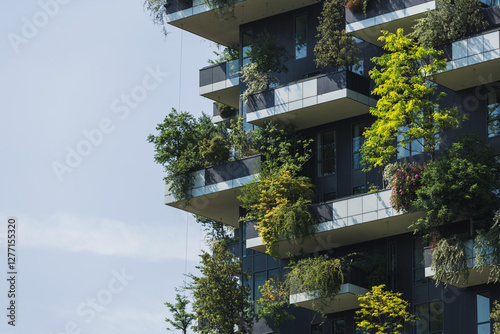 Residential tower, an example of modern architecture with various plants and tree-covered balconies. Sustainability and tree skyscraper concept. photo
