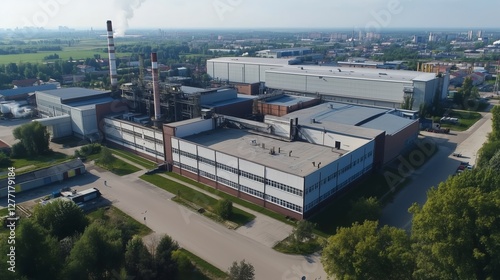 Industrial Facility Aerial View: Large buildings with smokestack emissions.