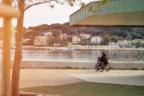 Disabled Person In The Wheelchair Outdoors Enjoying The Spectacular View Of Marine Bay