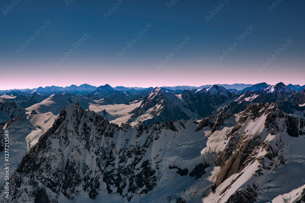 Flying over the southern alps mountain range at twilight