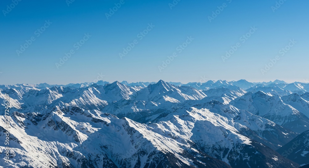 Majestic mountain range with snow-capped peaks and clear blue sky Majestic mountain range with snow-capped peaks and clear blue sky