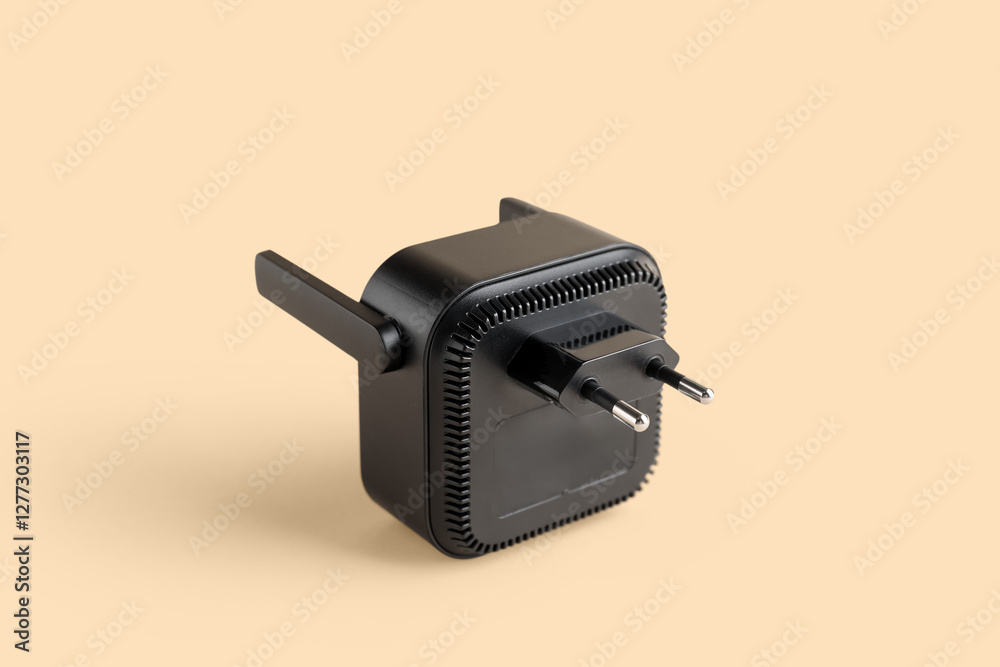 Black WiFi repeater on beige background Black WiFi repeater on beige background