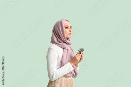 Young Muslim woman with Kor...