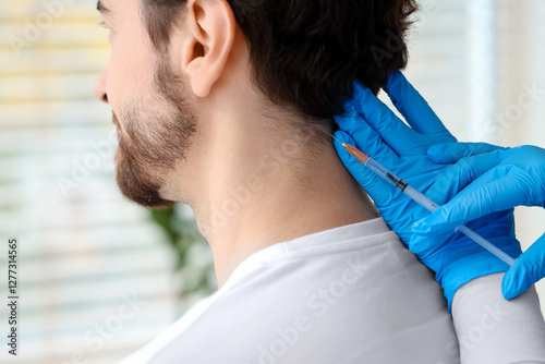 Young man receiving injecti...