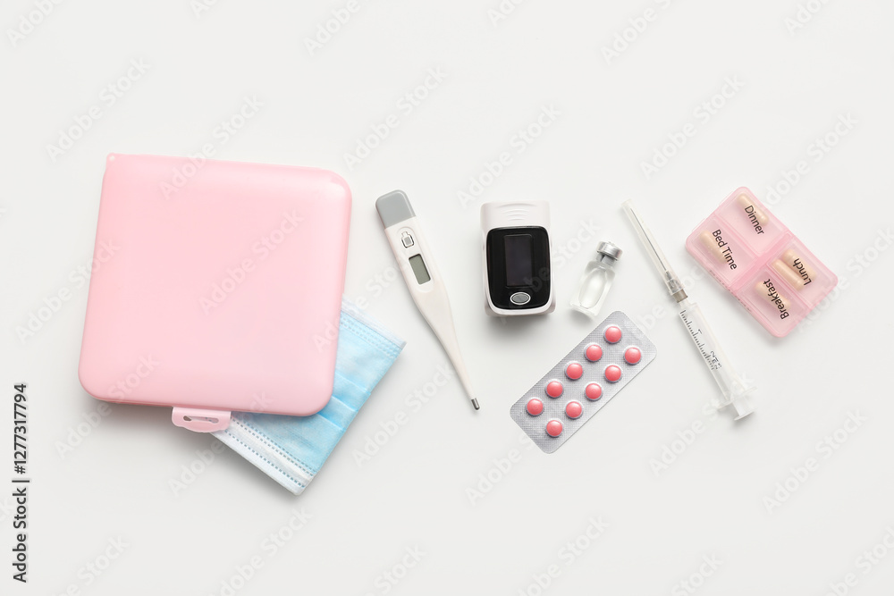 Fototapeta premium Pulse oximeter, thermometer, syringe, pill box and blister pack of pills on white background