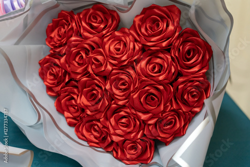 Heart-shaped bouquet of red roses presented on a table