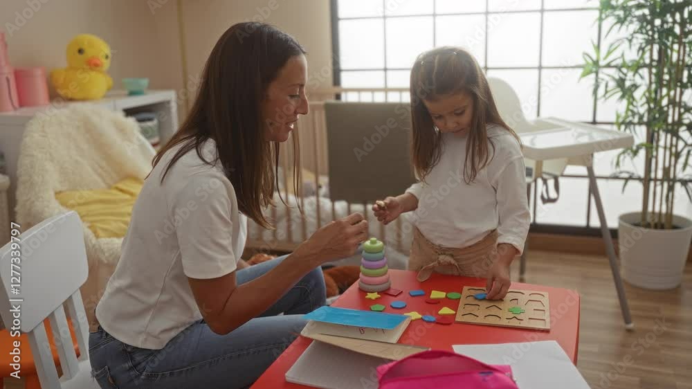 Woman and child playing with educational toys in a cozy nursery room, creating a warm and interactive environment for learning and bonding with toys on a red table. Woman and child playing with educational toys in a cozy nursery room, creating a warm and interactive environment for learning and bonding with toys on a red table.