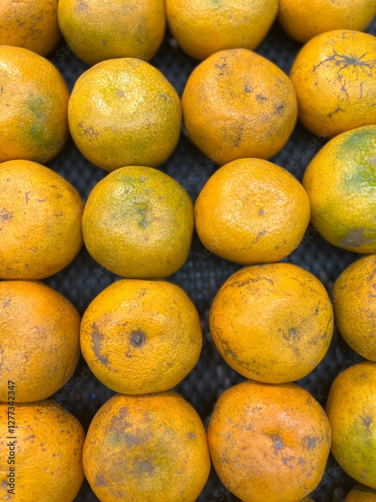 pile of oranges in a market stall pile of oranges in a market stall