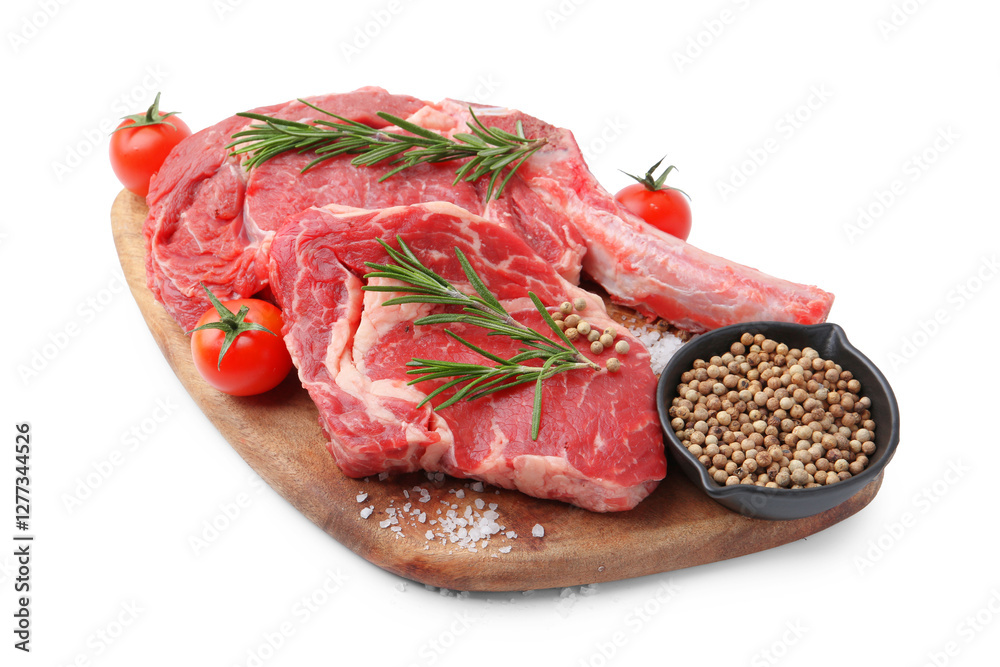 Pieces of raw beef meat, spices and tomatoes isolated on white Pieces of raw beef meat, spices and tomatoes isolated on white