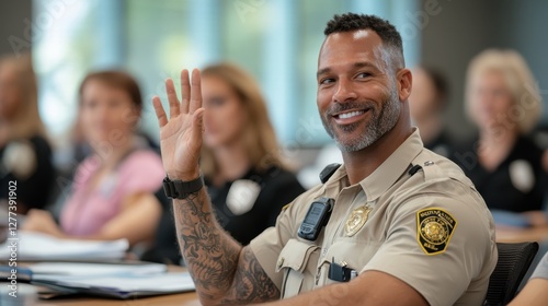 Engaged police officers in training session raising hands for questions