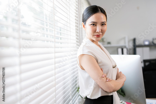 Smiling confident businesswoman with arms crossed standing in office. Free Download Smiling confident businesswoman with arms crossed standing in office. - GFXLoad