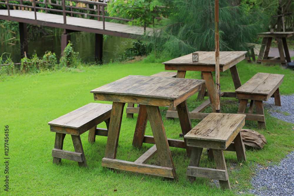 Wooden table and benches in the garden. Garden furniture for outdoor recreation. Wooden table and benches in the garden. Garden furniture for outdoor recreation.