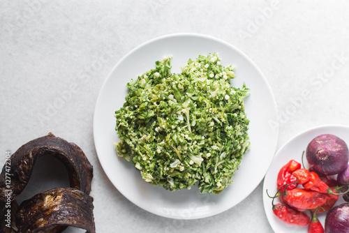 Overhead view of ingredients for making okro vegetable soup on a granite countertop, top view of mise en place of ingredients for making okro soup, process of making nigerian okro soup photo