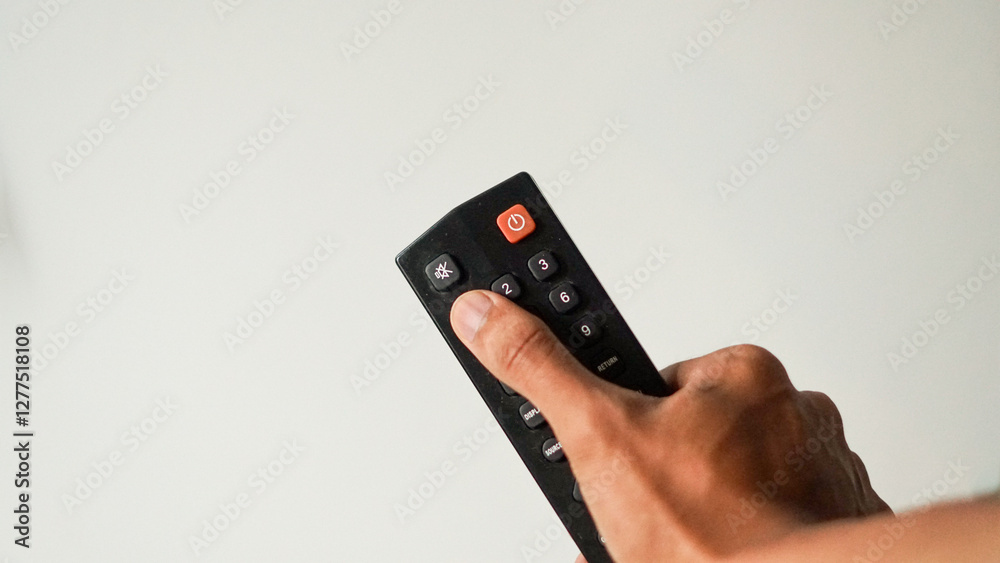 custom made wallpaper toronto digitalphoto of close up television remote. concept of hand holding television remote