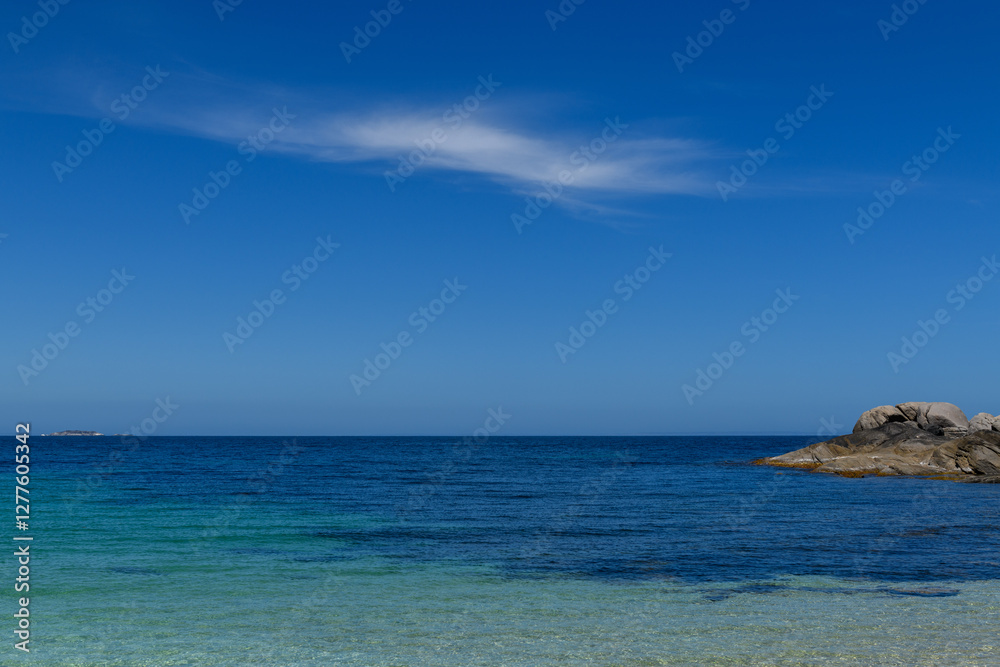 The beach on an isolated island and one lonely cloud The beach on an isolated island and one lonely cloud