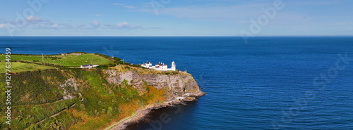 Panoramic Aerial view of Blackhead Lighthouse on the beautiful and spectacular coastline of the Glens of Antrim Northern Ireland