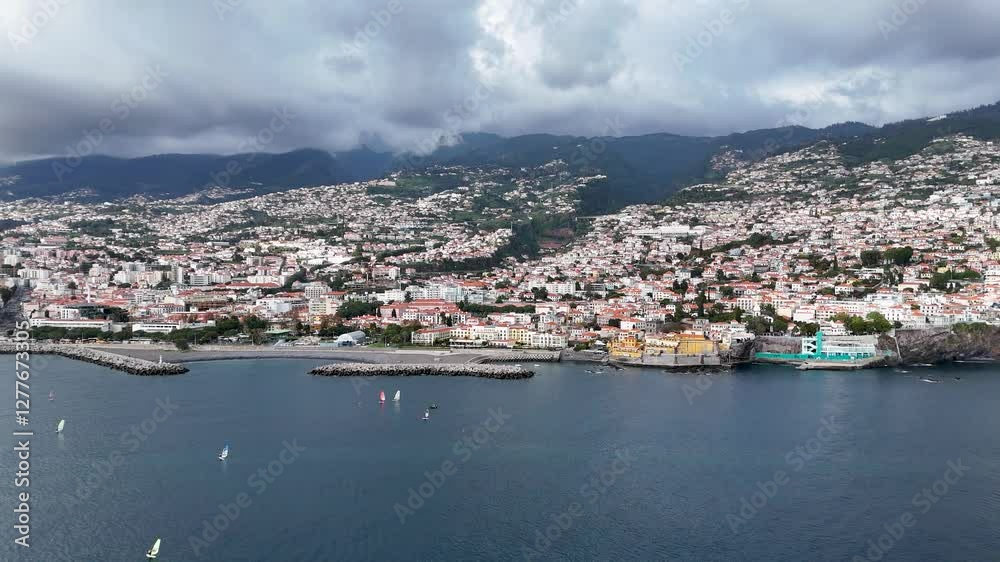 Rotating Aerial View of Funchal's Coastal Landscape Surrounded by the Atlantic Ocean and Mountains, Madeira Island Rotating Aerial View of Funchal's Coastal Landscape Surrounded by the Atlantic Ocean and Mountains, Madeira Island