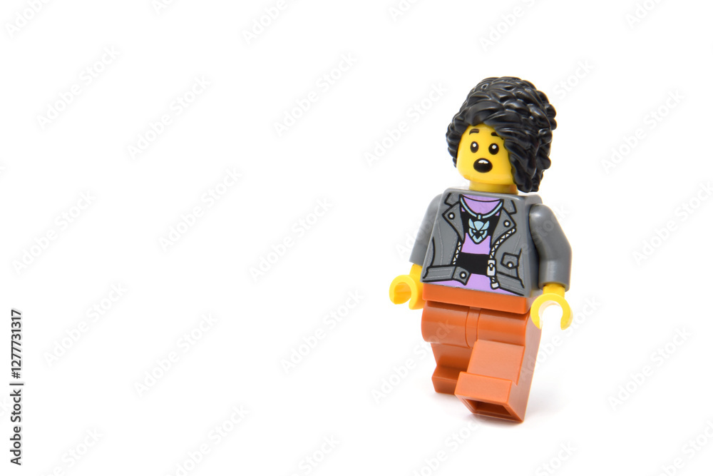 Naklejka premium Lego minifigure happy pretty girl or woman influencer isolated on white. Editorial illustrative image of popular children plastic toy.