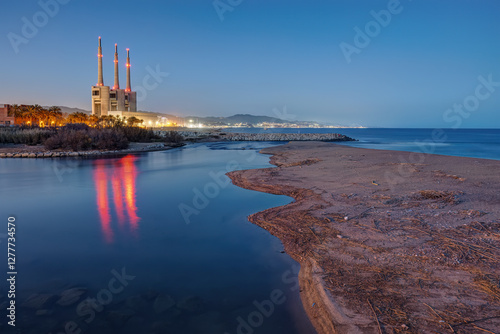 The shutdown thermal power station and the mouth of the Besos river at Sant Adria near Barcelona after sunset