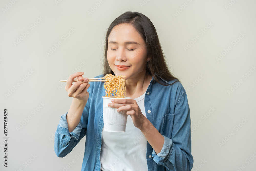 Happy temptation, attractive asian young student woman, cute girl using chopsticks eating instant ramen, noodles soup from a cup, cooking meal fast food lifestyle of traditional japanese person. Happy temptation, attractive asian young student woman, cute girl using chopsticks eating instant ramen, noodles soup from a cup, cooking meal fast food lifestyle of traditional japanese person.