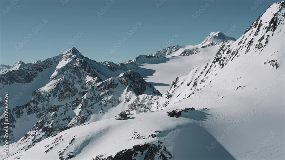 Drone shot of the snow-covered Otztal mountains in the Central Eastern Alps, Austria on a sunny day