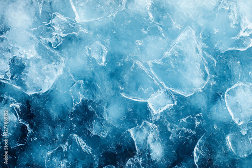 A close-up of a rugged icy surface with deep blue tones and crystalline formations. The detailed textures create a striking cold atmosphere, ideal for winter backgrounds or abstract designs