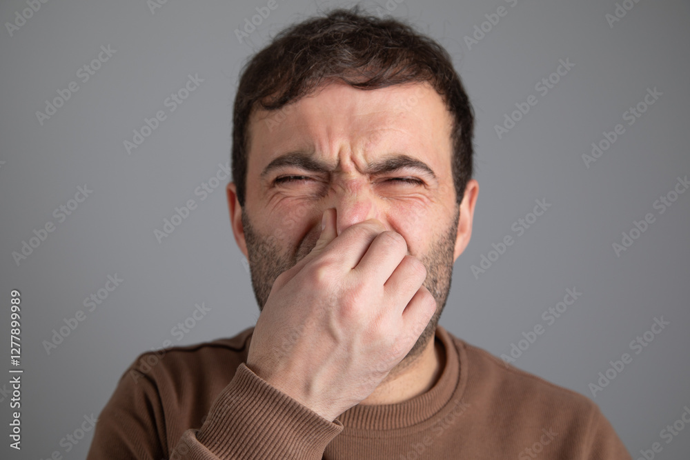 Caucasian man disgusted expression for stink. Caucasian man disgusted expression for stink.