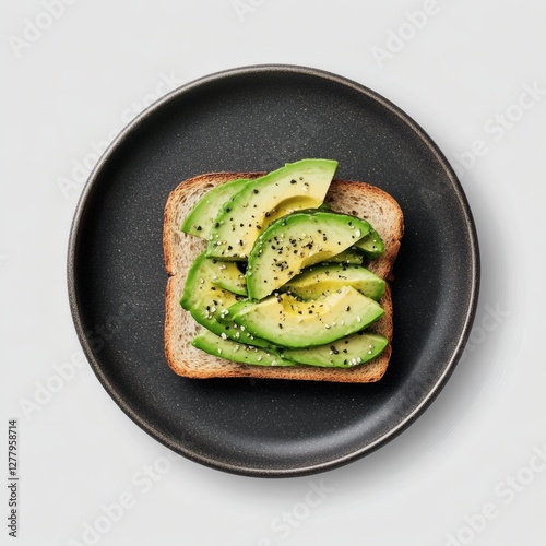 Delicious whole grain toast topped with fresh avocado slices and sprinkled with black pepper