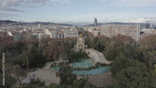 Bird's-eye view of residential areas, roads and sights of Barcelona in the rays of the rising sun, drone video