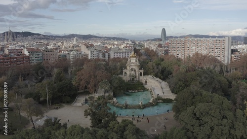 Bird's-eye view of residential areas, roads and sights of Barcelona in the rays of the rising sun, drone video