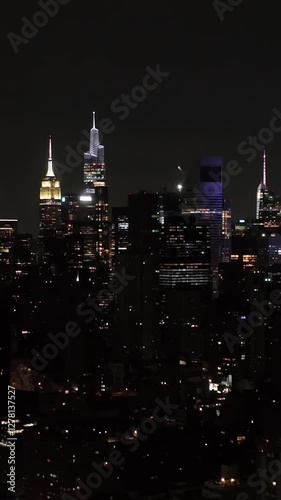 Wallpaper Mural Vertical drone shot of the illuminated skyline of Manhattan, night in New York Torontodigital.ca
