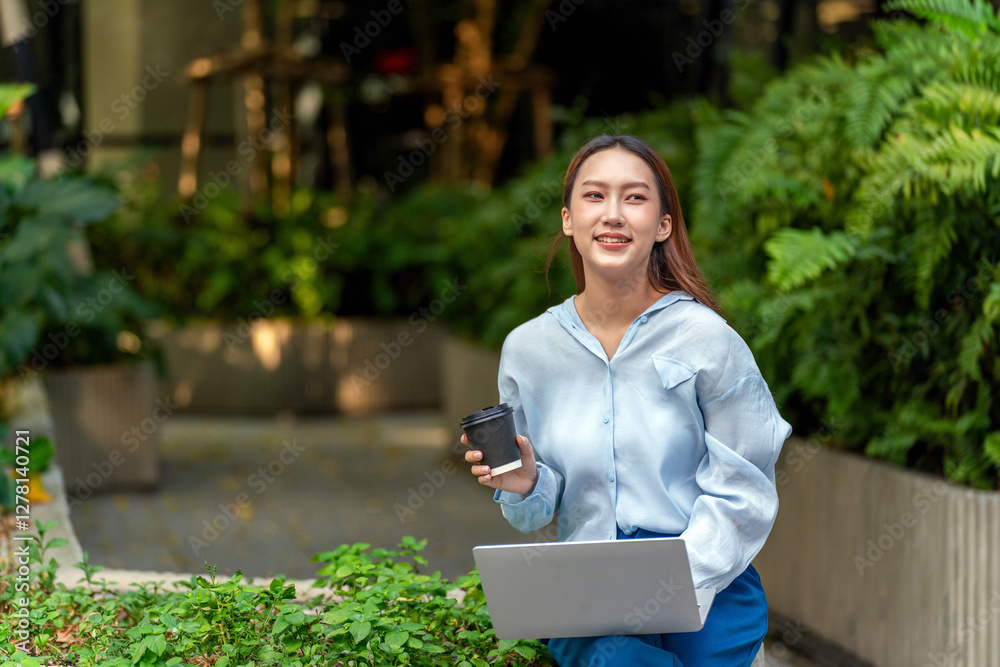 Young Asian Woman Using Laptop While Taking a Coffee Break Outdoors a Modern Urban Greenery Office Settings Young Asian Woman Using Laptop While Taking a Coffee Break Outdoors a Modern Urban Greenery Office Settings