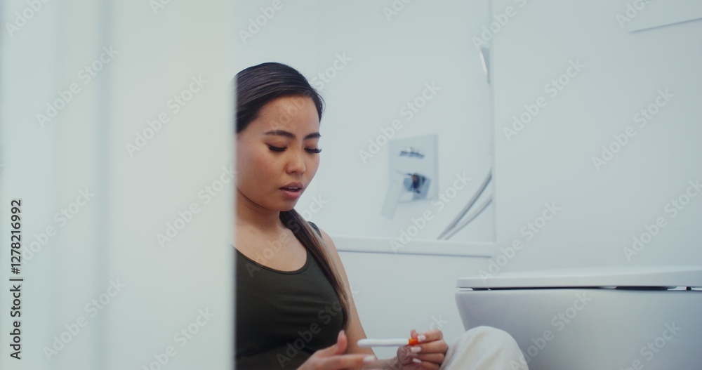 A young woman is worried about waiting for the result of a pregnancy test and rejoices at the positive result A young woman is worried about waiting for the result of a pregnancy test and rejoices at the positive result
