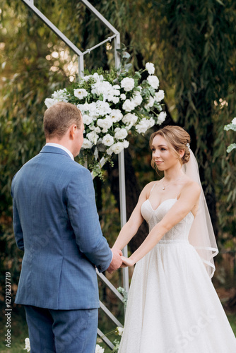 wedding ceremony of the newlyweds on the glade