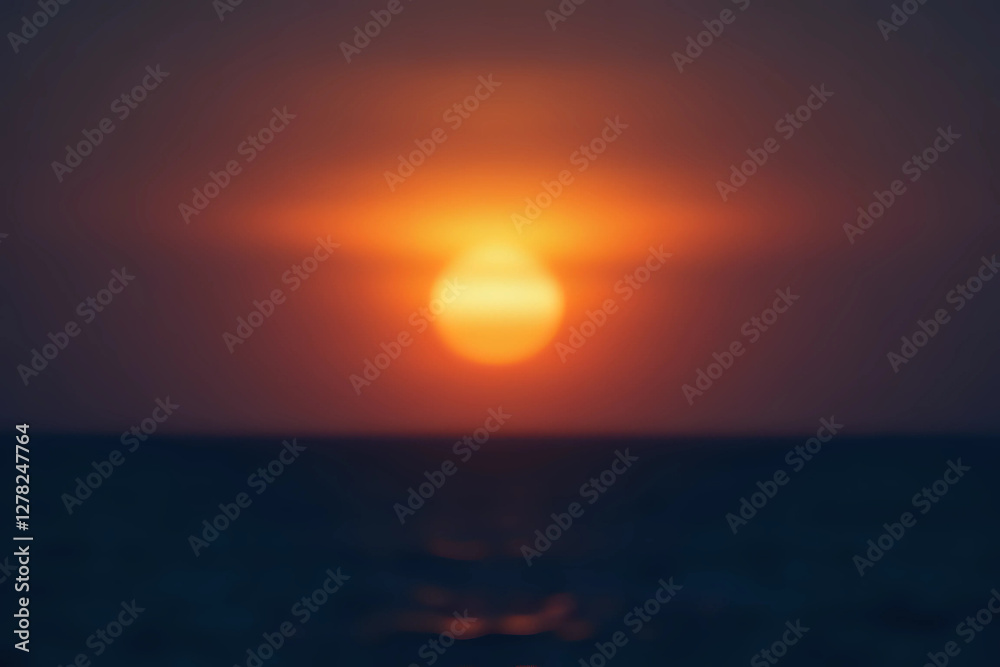 Out of focus sun setting over the ocean glowing orange with dark blue background. Out of focus sun setting over the ocean glowing orange with dark blue background.