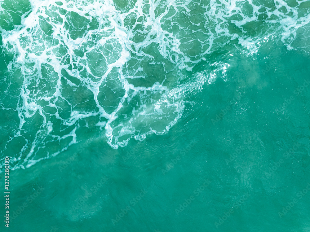 Overhead view turquoise stormy ocean waves with white foam in the ocean,Sea water with splashes and foam, Top view waves background, Natural background photo sea texture with waves soft focus Overhead view turquoise stormy ocean waves with white foam in the ocean,Sea water with splashes and foam, Top view waves background, Natural background photo sea texture with waves soft focus