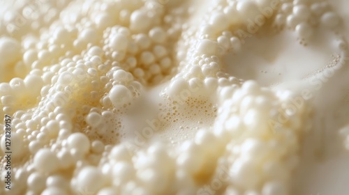 bubbling kefir fermentation, with the healthy grains of yeast and bacteria transforming the milk into a creamy probiotic drink.