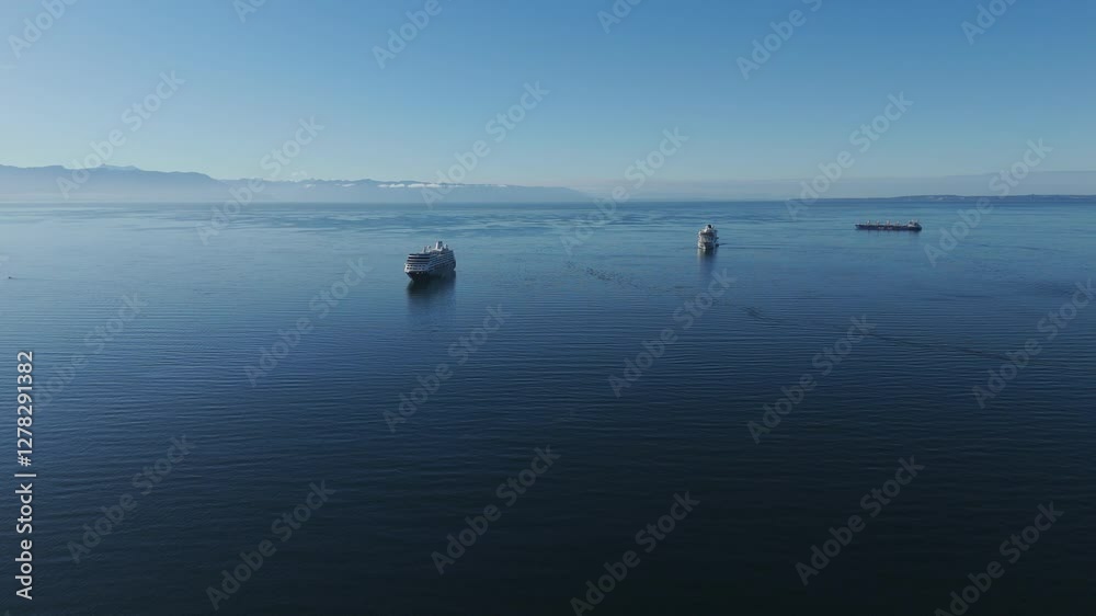 Aerial view of cruise ships sailing on a sunny day near Puerto Montt, Chile, with mountains in the background Aerial view of cruise ships sailing on a sunny day near Puerto Montt, Chile, with mountains in the background