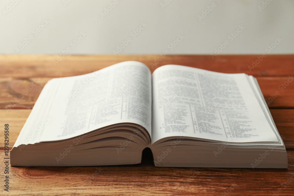 Open Holy Bible in English language on wooden table, closeup Open Holy Bible in English language on wooden table, closeup