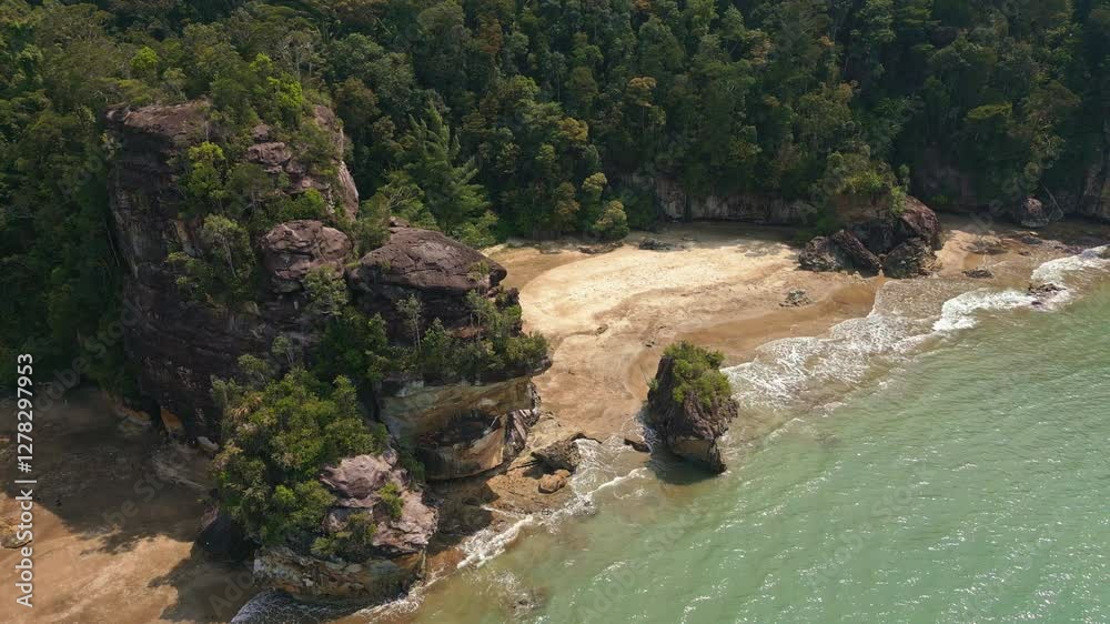 Drone shot of a tropical beach surrounded by lush rainforest Drone shot of a tropical beach surrounded by lush rainforest