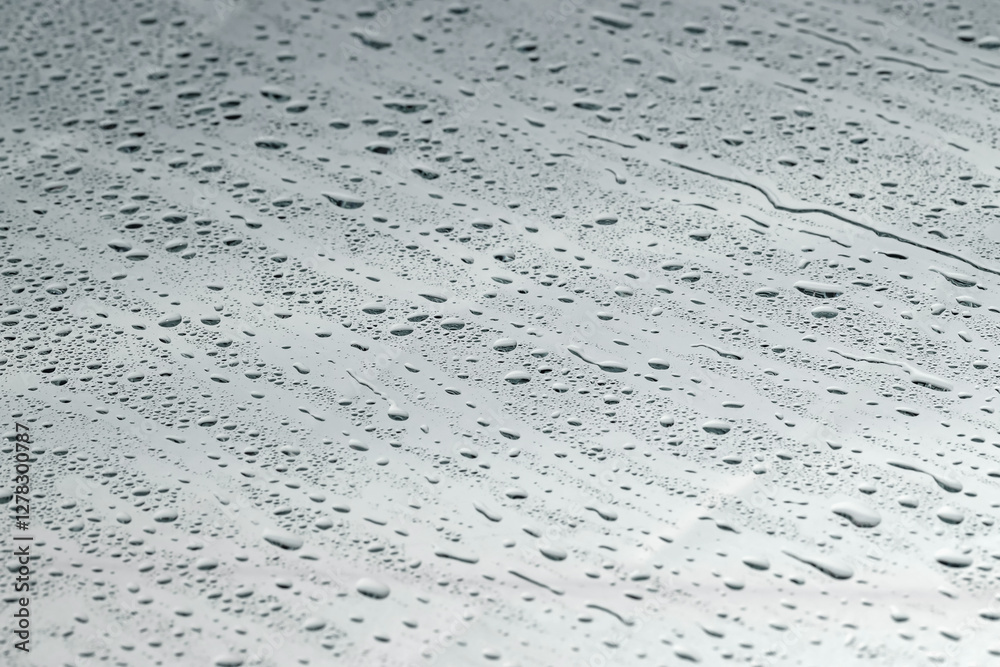Water drops on grey glass surface, closeup Water drops on grey glass surface, closeup