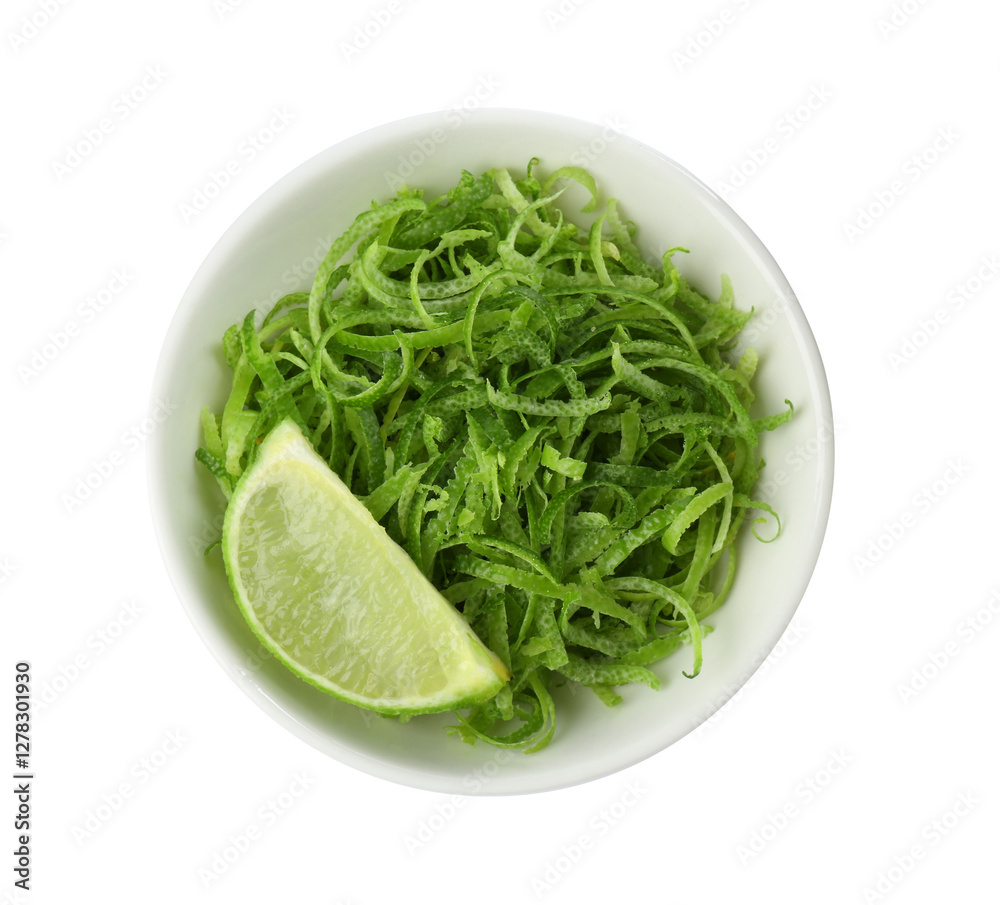 Lime zest and piece of fruit in bowl isolated on white, top view Lime zest and piece of fruit in bowl isolated on white, top view