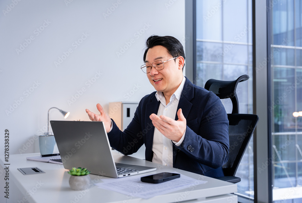 Professional businessman in a stylish office engaging in a virtual conference using a laptop, demonstrating effective communication and business organization in a corporate environment. Professional businessman in a stylish office engaging in a virtual conference using a laptop, demonstrating effective communication and business organization in a corporate environment.