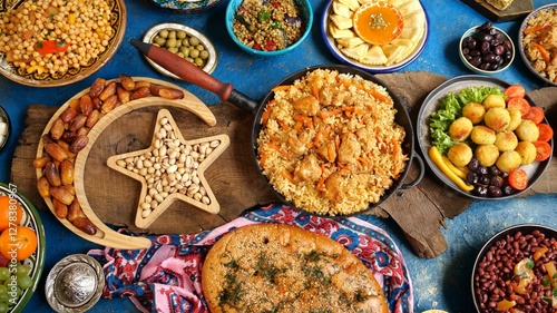 Ramadan Iftar food on the table. Women's hands serve a table for iftar dinner. Traditional Falafel